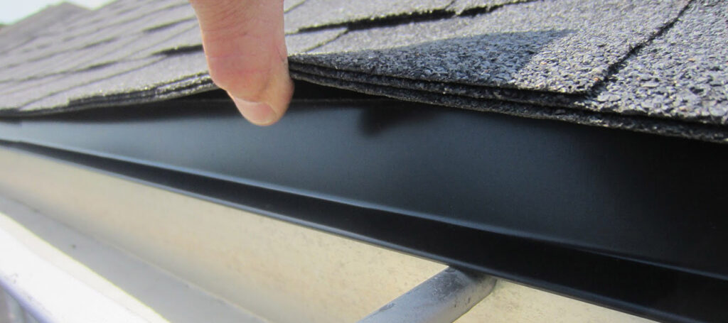Drip edge flashing under shingle roofing.