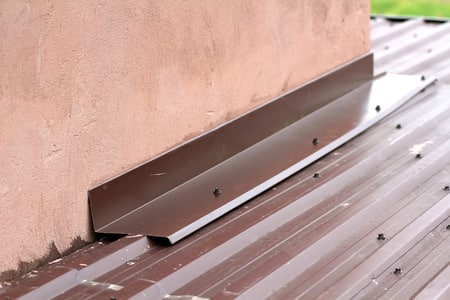 Drip flashing on wall/roof connection.